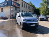 a van parked in front of a building with cars parked in front of it