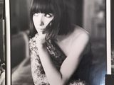 a black and white photo of a woman sitting in a chair