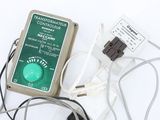 an electronic device that is connected to wires on a white surface
