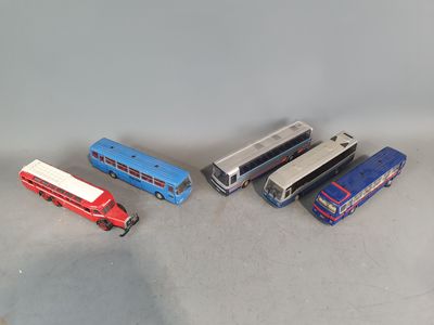several toy buses and trucks are lined up on a table