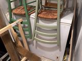 a stack of ladders sitting on top of a washing machine