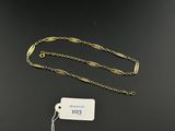 a close up of a gold chain with a tag on it