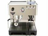 the coffee machine is sitting on the table ready to be used