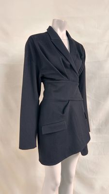 a close up of a mannequin mannequin wearing a black jacket and skirt