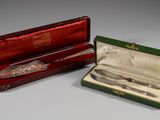 two silverware items in a red box on a table