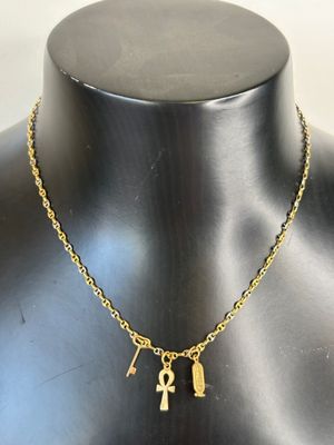 a gold necklace with an ankht and an ankht on it