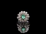 an emerald and diamond cluster ring