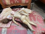 a doll that is laying on a chair in a room