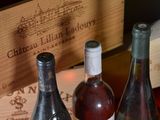 several bottles of wine sitting on a table next to a wooden box