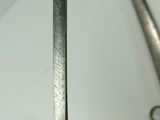 someone is holding a pair of scissors in their hand while they are on a table