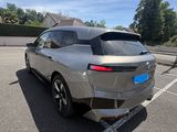 the rear end of a silver car parked in a parking lot