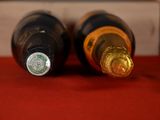two bottles of wine sitting next to each other on a table