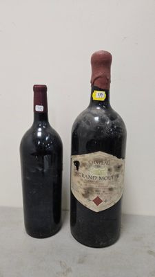 two bottles of wine sitting next to each other on a table