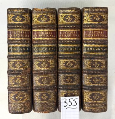 a group of five old books sitting on top of each other