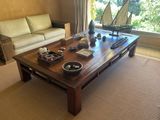 a coffee table with a boat on it in a living room