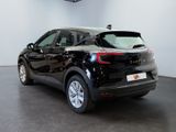 the back of a black car is parked in a showroom