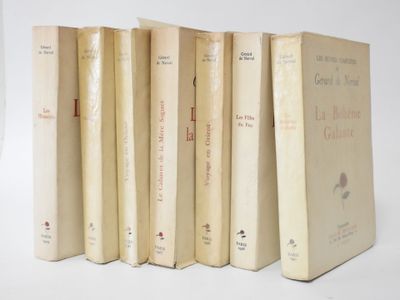 six books are lined up in a row on a white surface