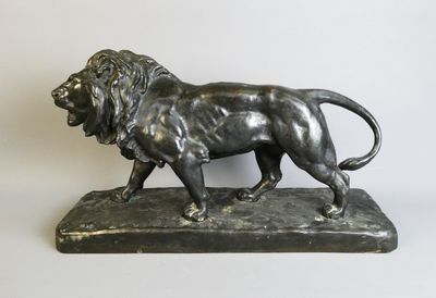 bronze statue of a lion on a marble base on a white background