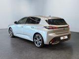 the rear end of a silver car in a white room