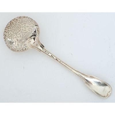 an antique silver spoon with a flower design on it and a spoon in the shape of a flower