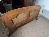 a bed with a wooden headboard and foot board in a room
