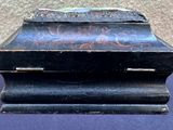 a small black box with writing on it sitting on a table