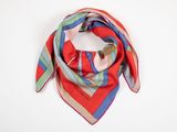 a close up of a red and blue scarf on a white surface