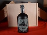 a bottle of liquor sitting on a table next to a box