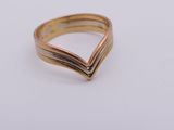 a close up of a gold ring on a white surface
