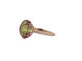 a close up of a ring with a green tourmaline and pink tourmaline