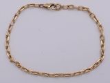 a gold chain bracelet with a heart clasp