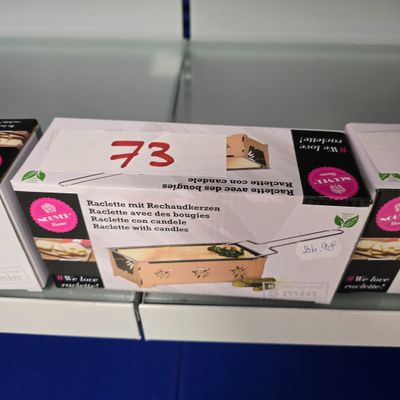 trois boîtes de nourriture posées sur une étagère dans un magasin