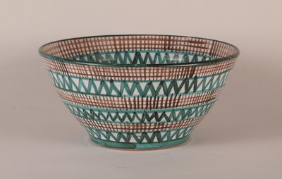 a blue and brown bowl sitting on a white surface