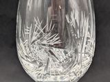 a wine glass with a pinecone design on it