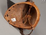 a baseball helmet with a baseball bat hanging from it ' s side