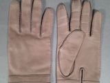 pair of tan leather gloves with stitching on the fingers