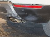 a close up of a car ' s rear bumper and exhaust muffler