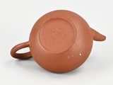 a small brown cup with a handle on a white surface