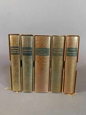 five books are lined up in a row on a gray surface