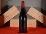 a bottle of wine sitting on a table with wooden blocks