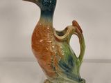 a ceramic bird that is sitting on a table