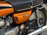 an orange motorcycle parked on the side of the road