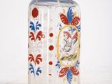 a glass bottle with a picture of a bird on it