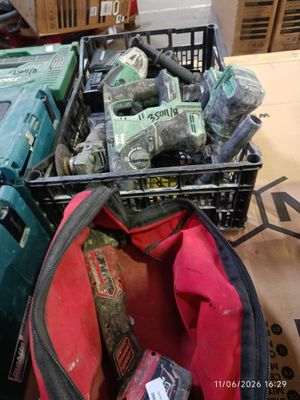 a basket full of tools sitting on the floor