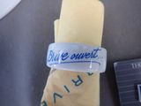 a bracelet with a message on it sitting next to a credit card