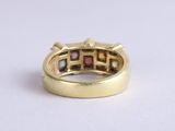 an image of a gold ring with multi colored stones in it
