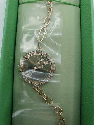 an image of a watch in a box with a chain around it