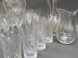 a lot of glasses and a pitcher on the table