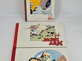 two children ' s books are sitting on a white surface