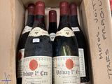three bottles of wine in a box on a table
